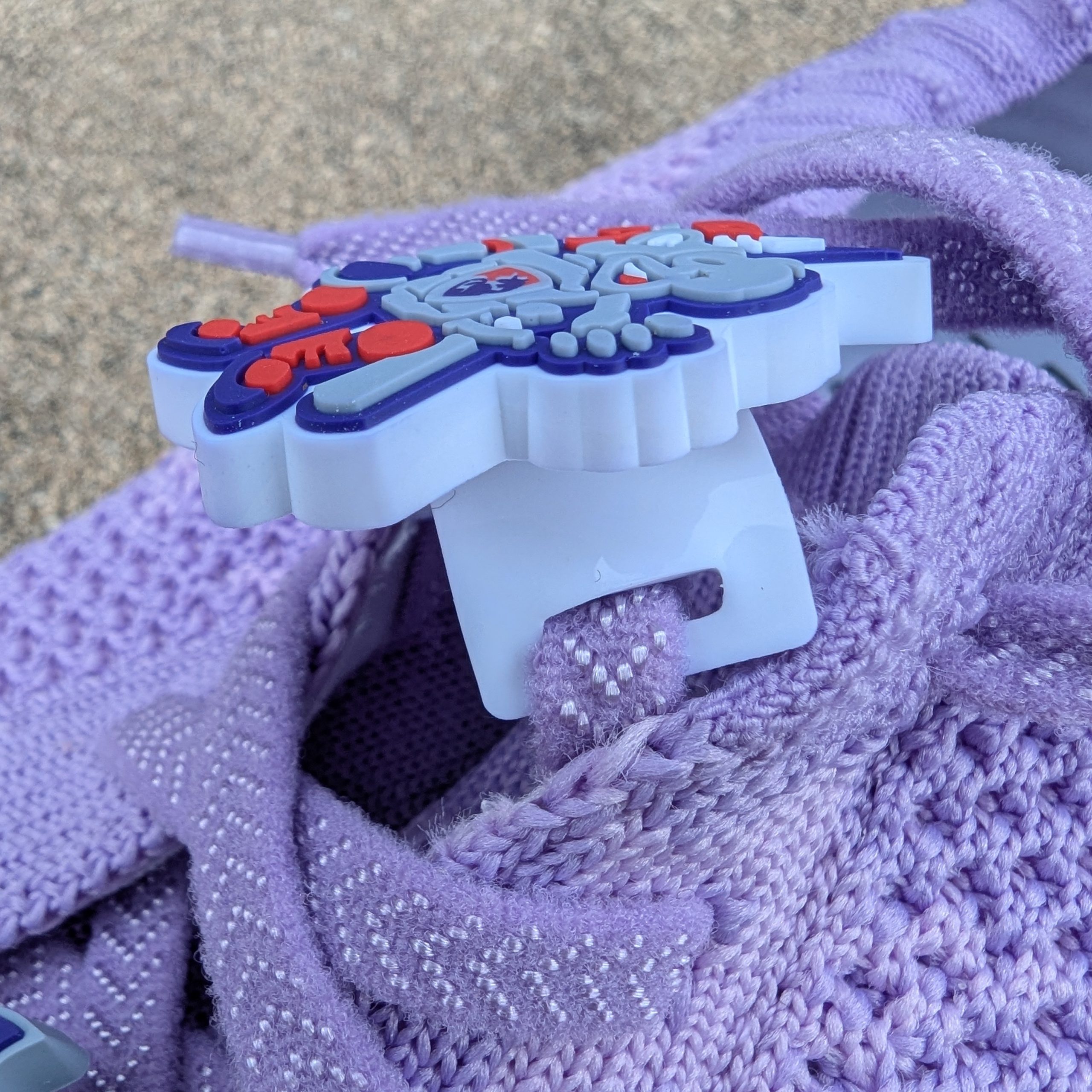 close up of Unicorns shoe charm showing shoe lace attachment